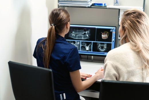 Dental team members looking at digital x rays