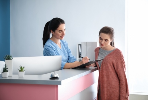 Woman visiting the dentist to prevent dental emergencies