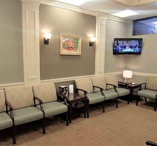 Empty chairs in waiting room of dental office in Lowell