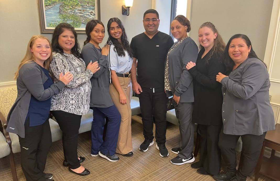 Smiling dentists and dental team members at Simply Dental of Lowell