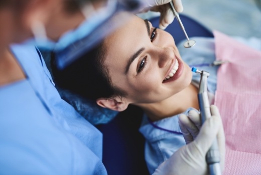 Woman smiling during preventive dentistry checkup and teeth cleaning visit