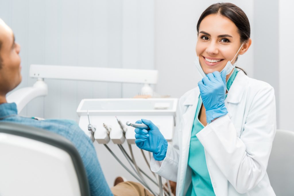 Female dentist smiling during dental checkup