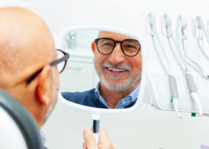 a person admiring their dental implants